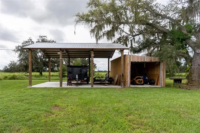 a view of a house with backyard porch and sitting area