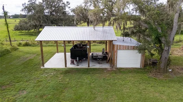 a view of a house with backyard porch and sitting area