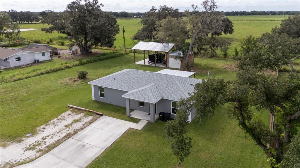 1833 Southeast Tangelo Drive Arcadia, FL 34266 - Photo 34 of 38 a view of a house with a yard and lake view