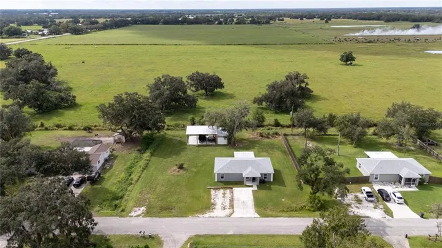 an aerial view of a houses with a lake view