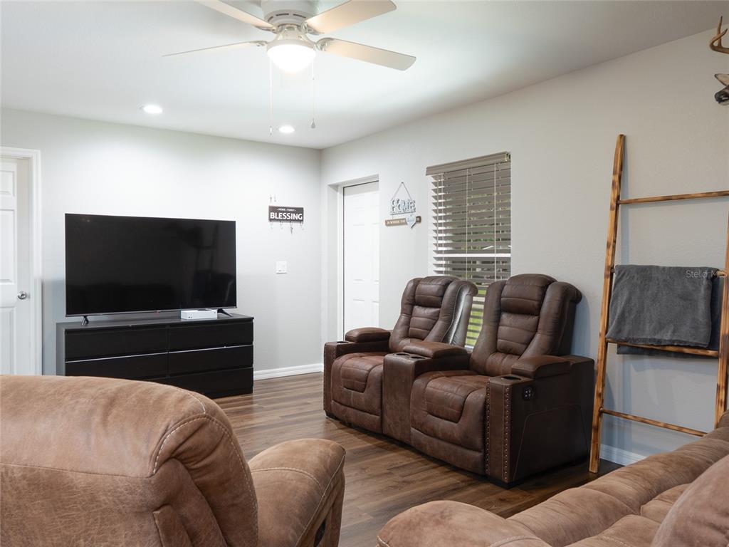1833 Southeast Tangelo Drive Arcadia, FL 34266 - Photo 7 of 38 a living room with furniture and a flat screen tv