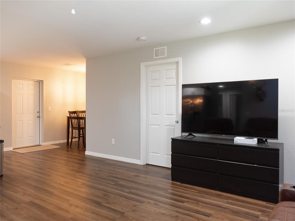 1833 Southeast Tangelo Drive Arcadia, FL 34266 - Photo 8 of 38 a room with wooden floor and furniture