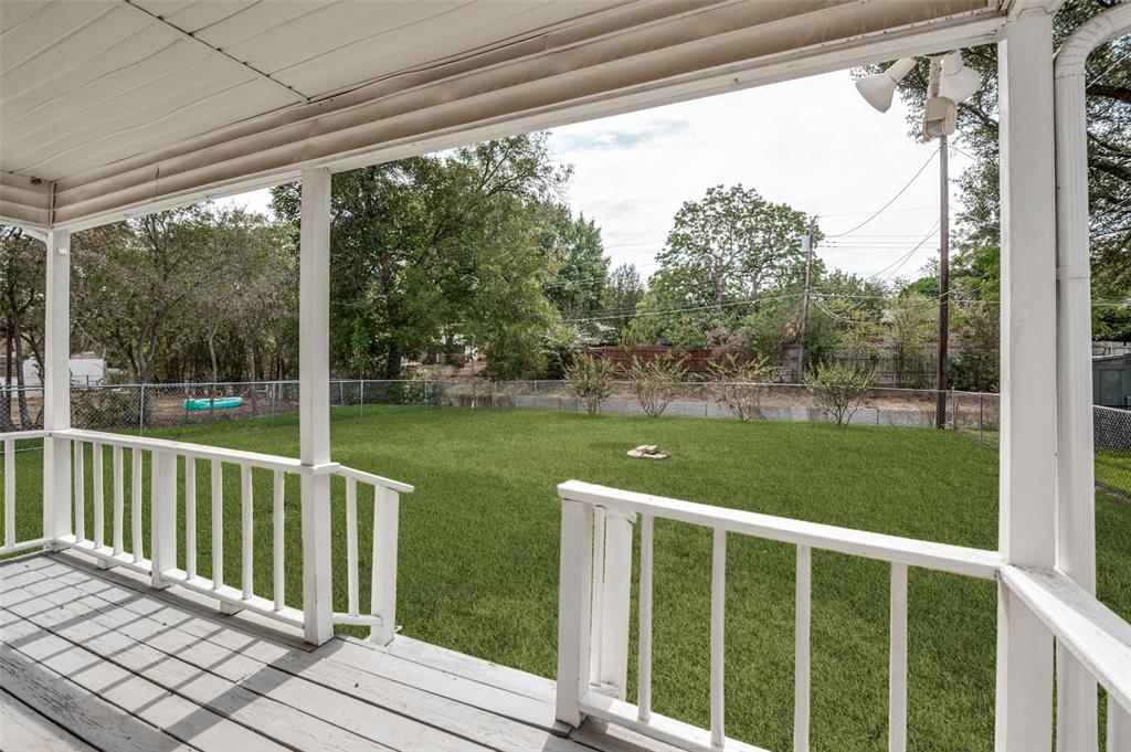 2528 Rugby Lane Farmers Branch, TX 75234 - Photo 11 of 12 Covered porch with painted wood decking, white railings, and a spacious green lawn