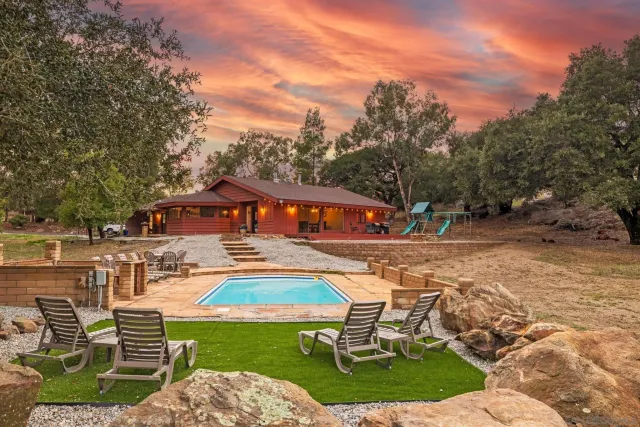 an outdoor space with swimming pool and furniture