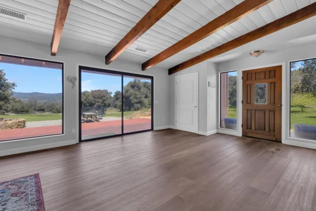 a view of a livingroom with furniture and a window