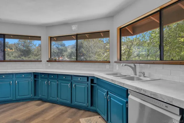 a large kitchen with a table and chairs