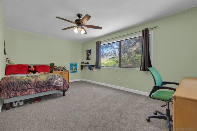 a bathroom with a granite countertop sink a toilet and a mirror