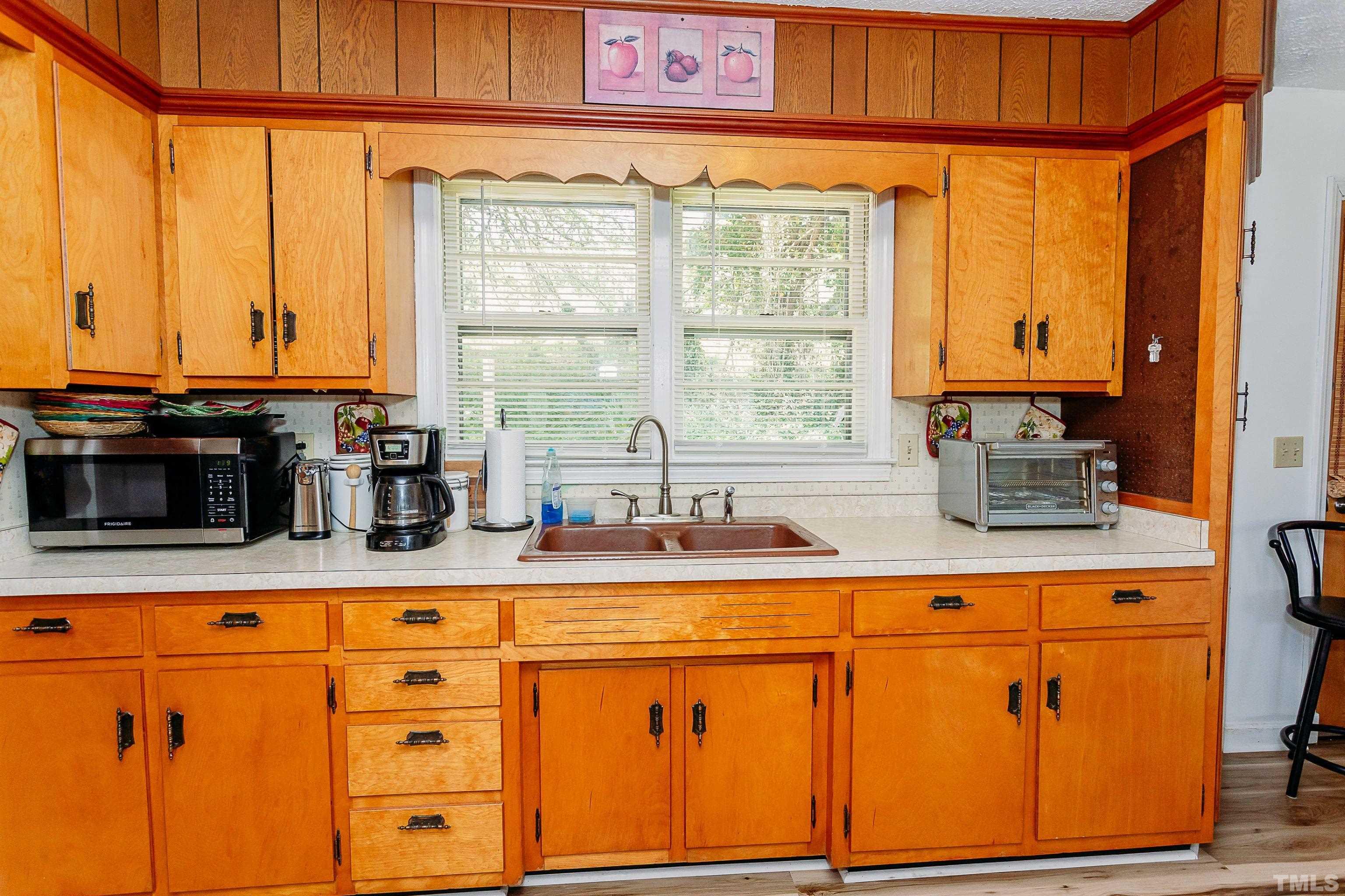 601 Fees Branch Road Lansing, NC 28643 - Photo 25 of 72 a kitchen with stainless steel appliances granite countertop a sink a stove and a microwave