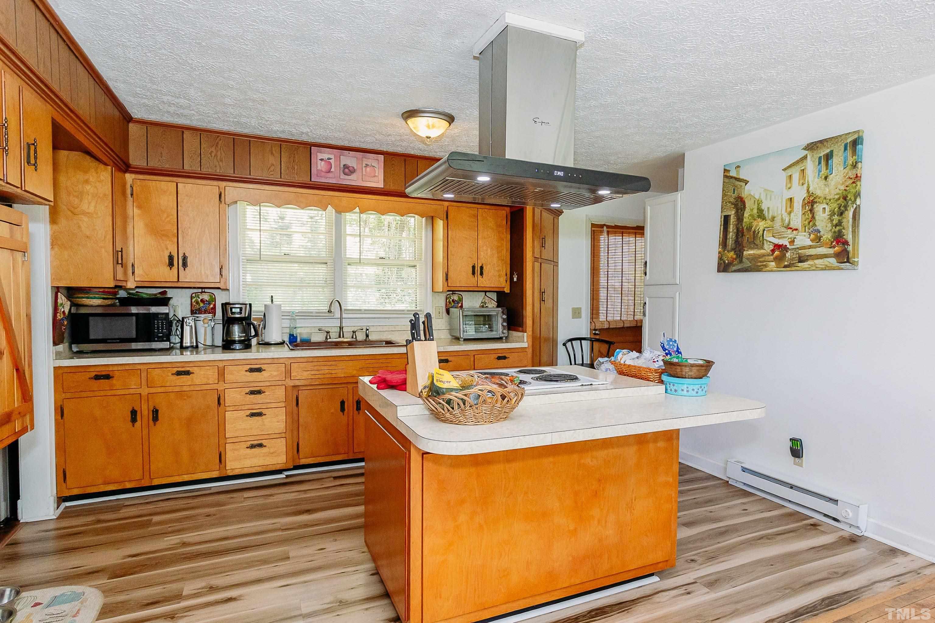 601 Fees Branch Road Lansing, NC 28643 - Photo 26 of 72 a kitchen with stainless steel appliances granite countertop a stove a sink and a microwave