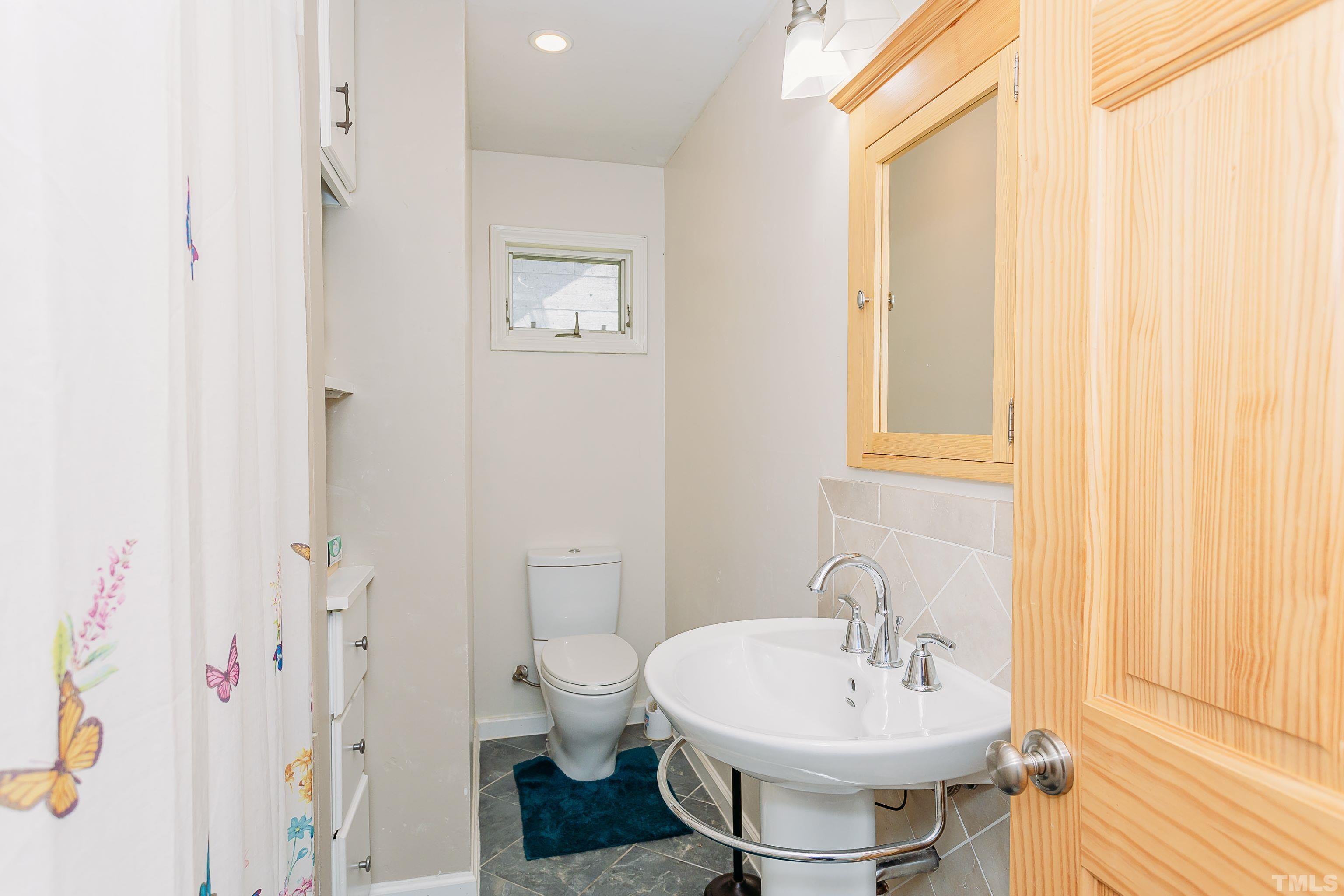 601 Fees Branch Road Lansing, NC 28643 - Photo 27 of 72 a bathroom with a sink a toilet and shower curtain