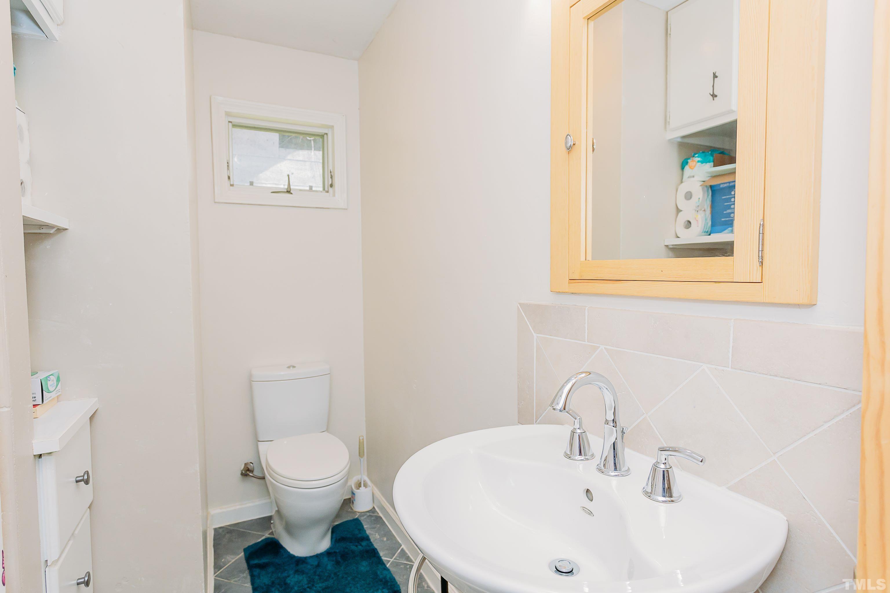 601 Fees Branch Road Lansing, NC 28643 - Photo 28 of 72 a bathroom with a toilet a sink and mirror