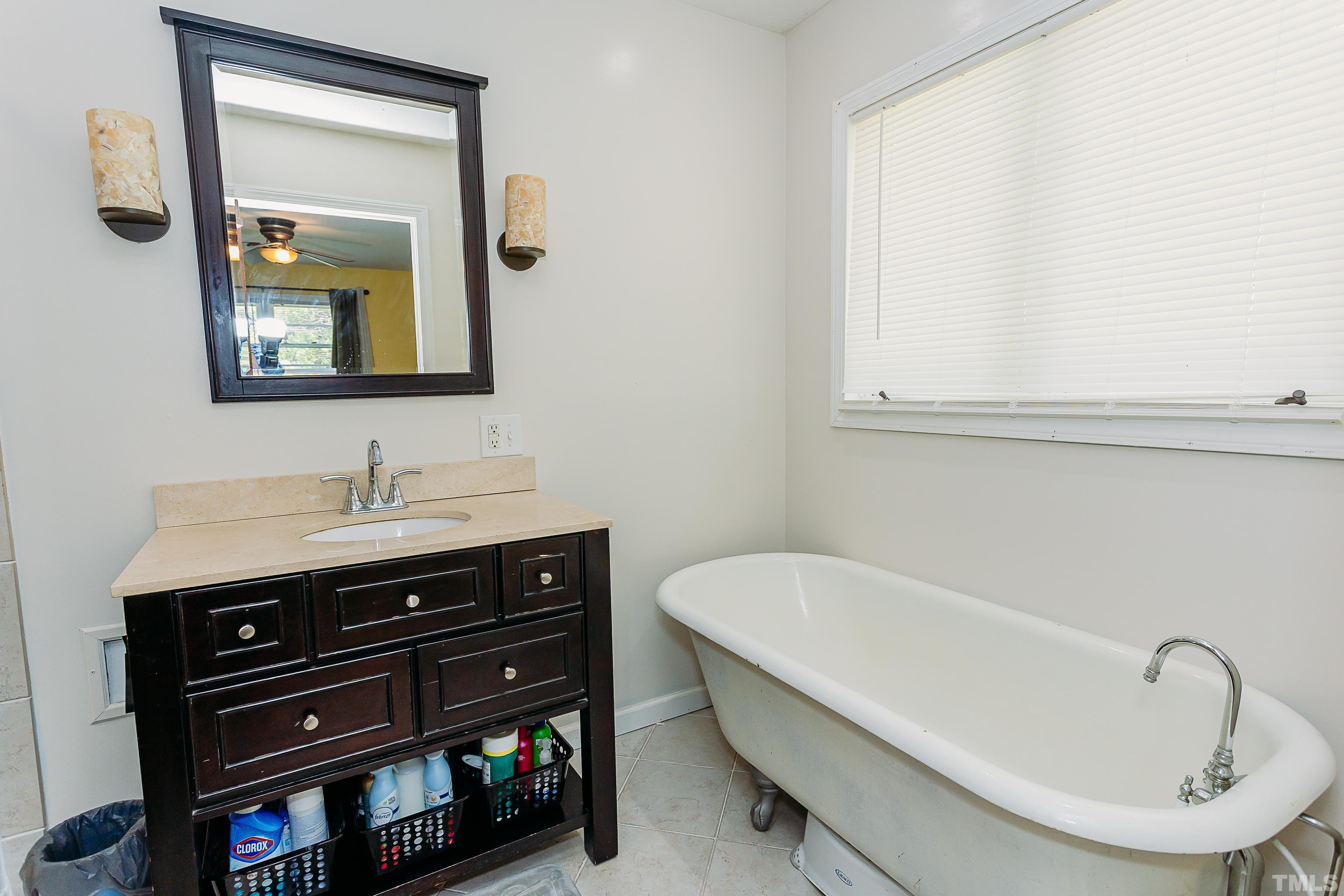 601 Fees Branch Road Lansing, NC 28643 - Photo 43 of 72 a bathroom with a bathtub sink and mirror