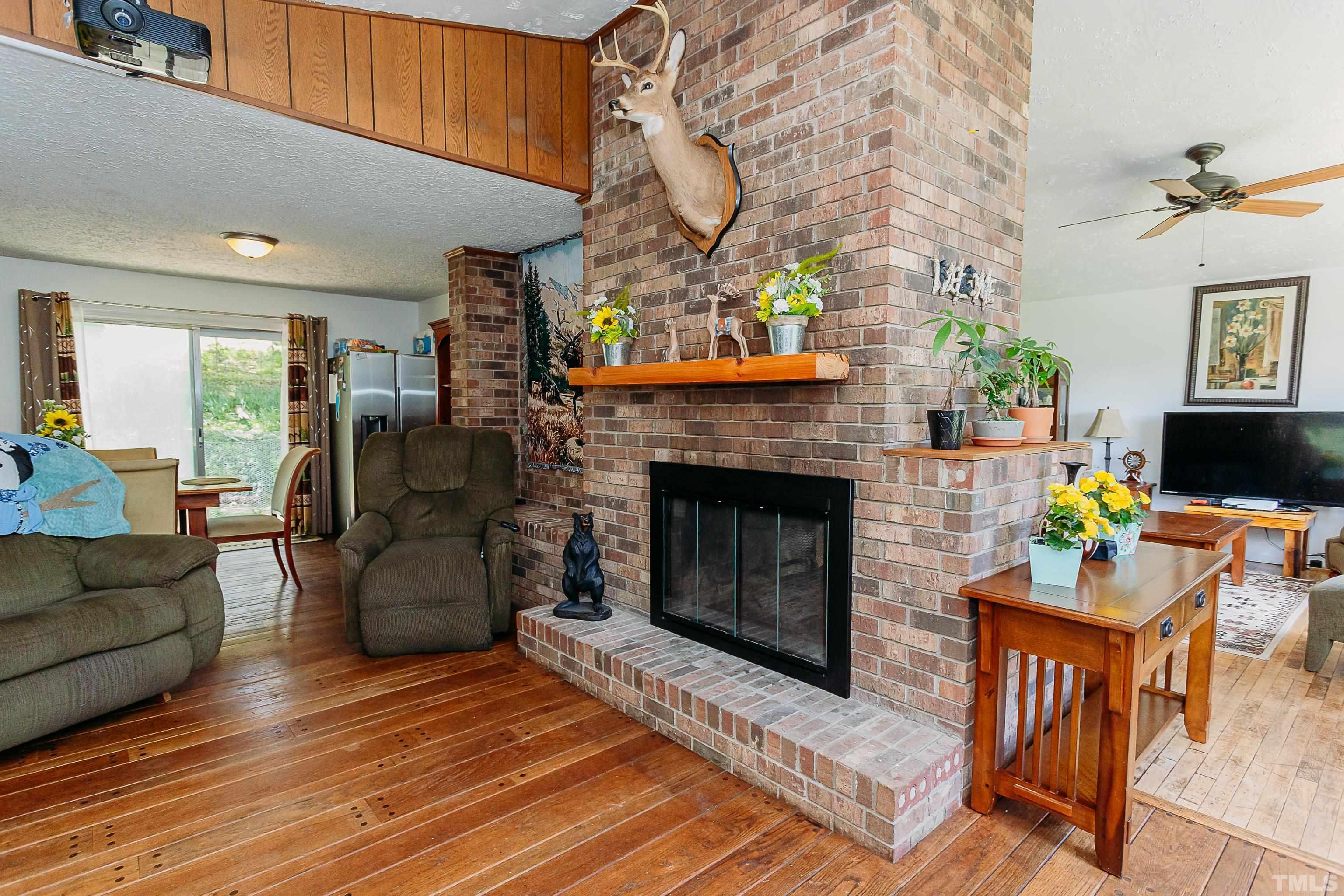 601 Fees Branch Road Lansing, NC 28643 - Photo 48 of 72 a living room with furniture a flat screen tv and a fireplace