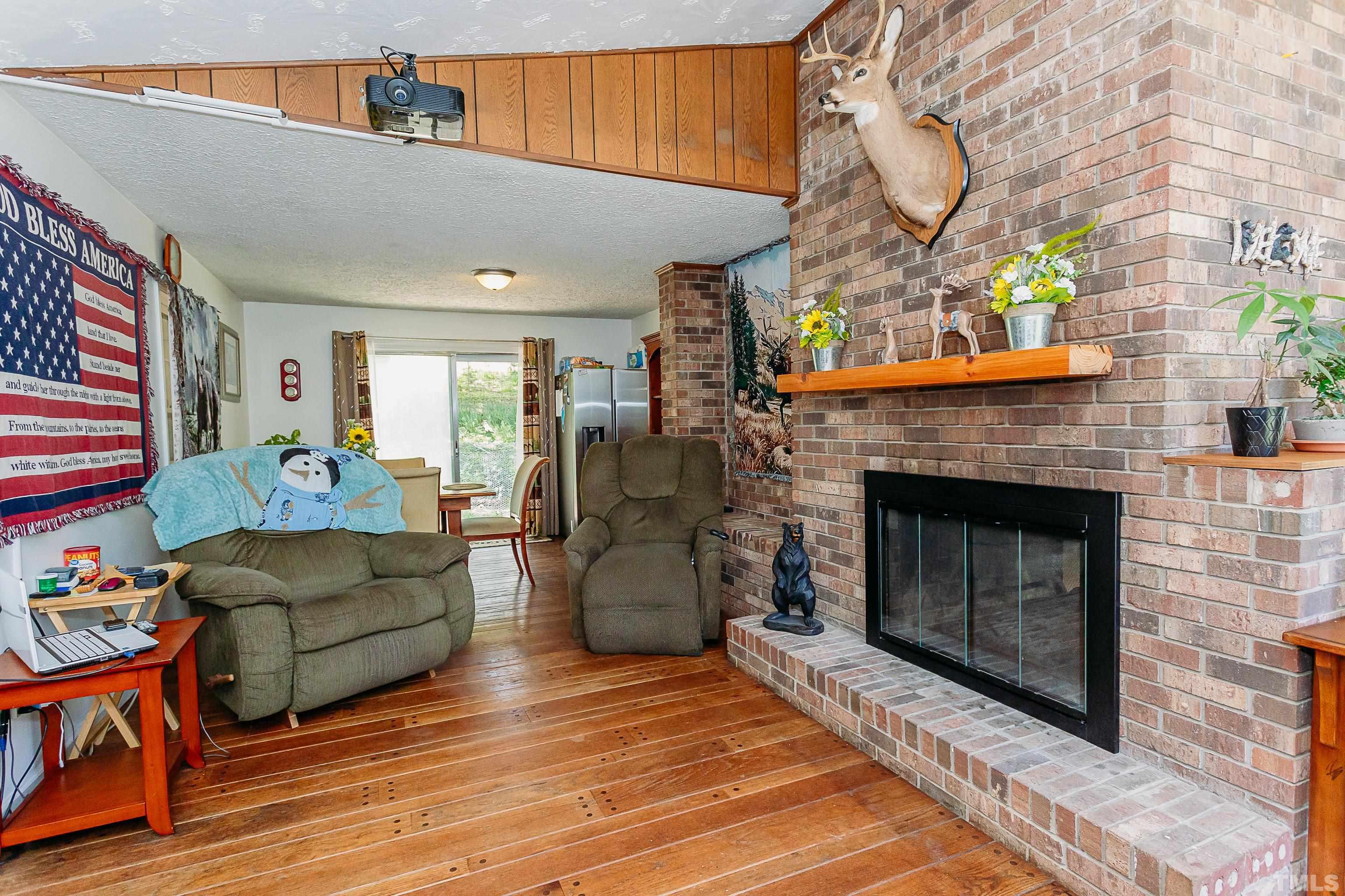 601 Fees Branch Road Lansing, NC 28643 - Photo 49 of 72 a living room with furniture a flat screen tv and a fireplace