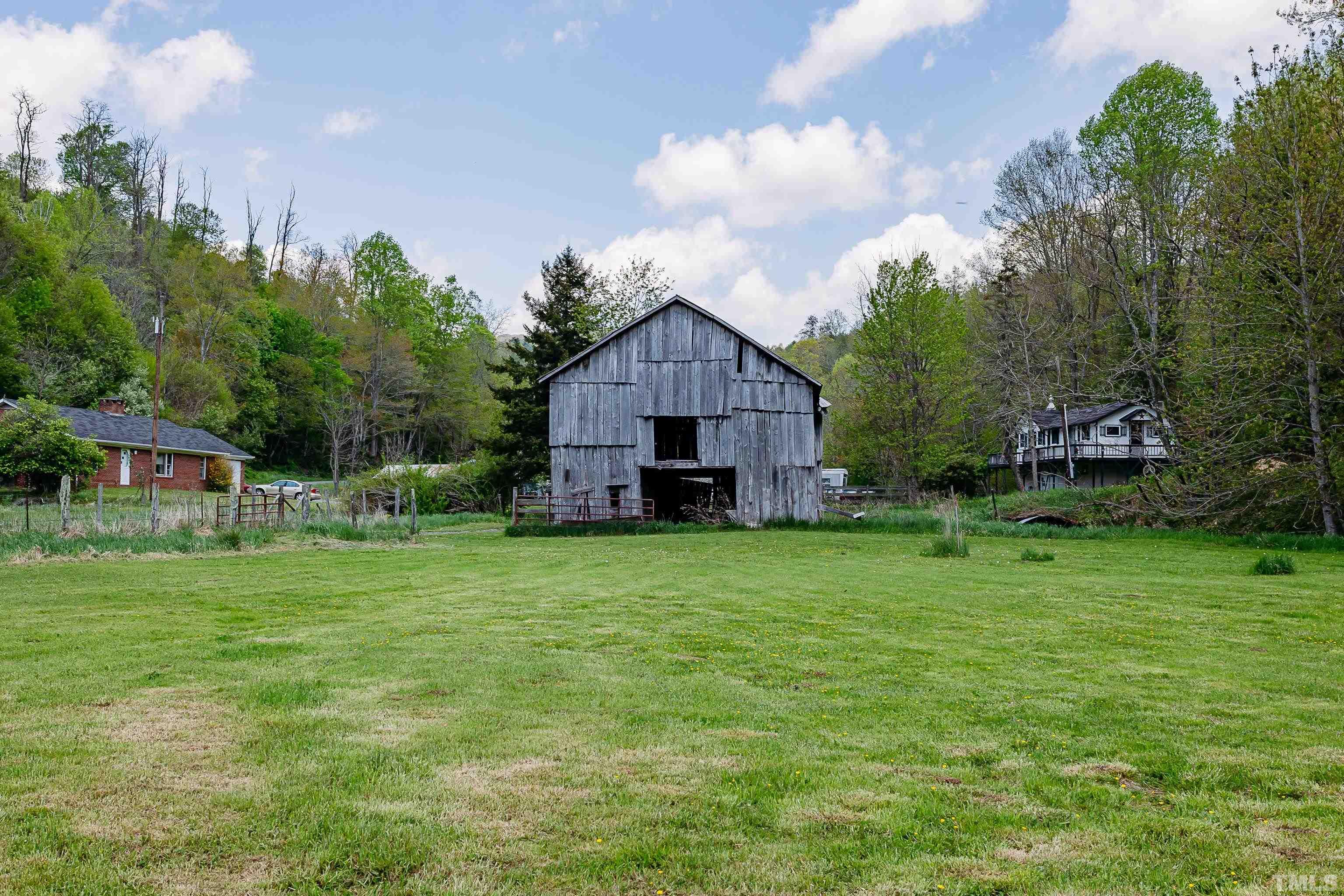 601 Fees Branch Road Lansing, NC 28643 - Photo 6 of 72 a view of a big house with a big yard and large trees