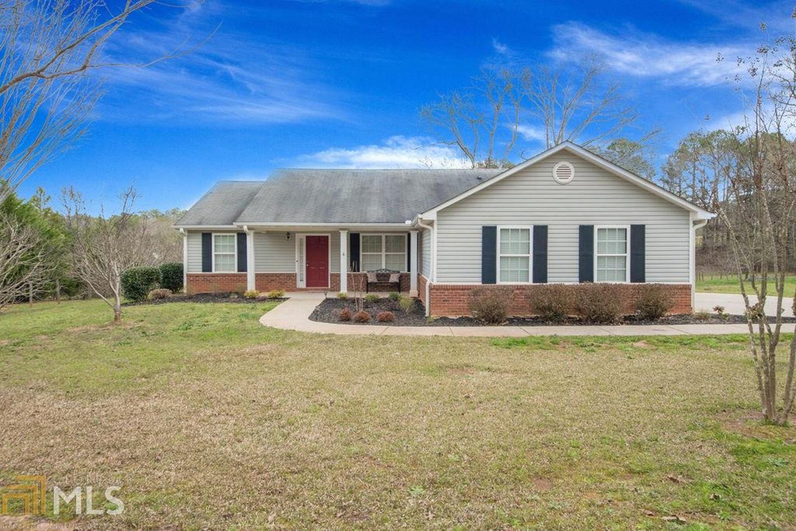223 Jack Russell Road Newnan, GA 30263 - Photo 1 of 1 a front view of a house with a garden