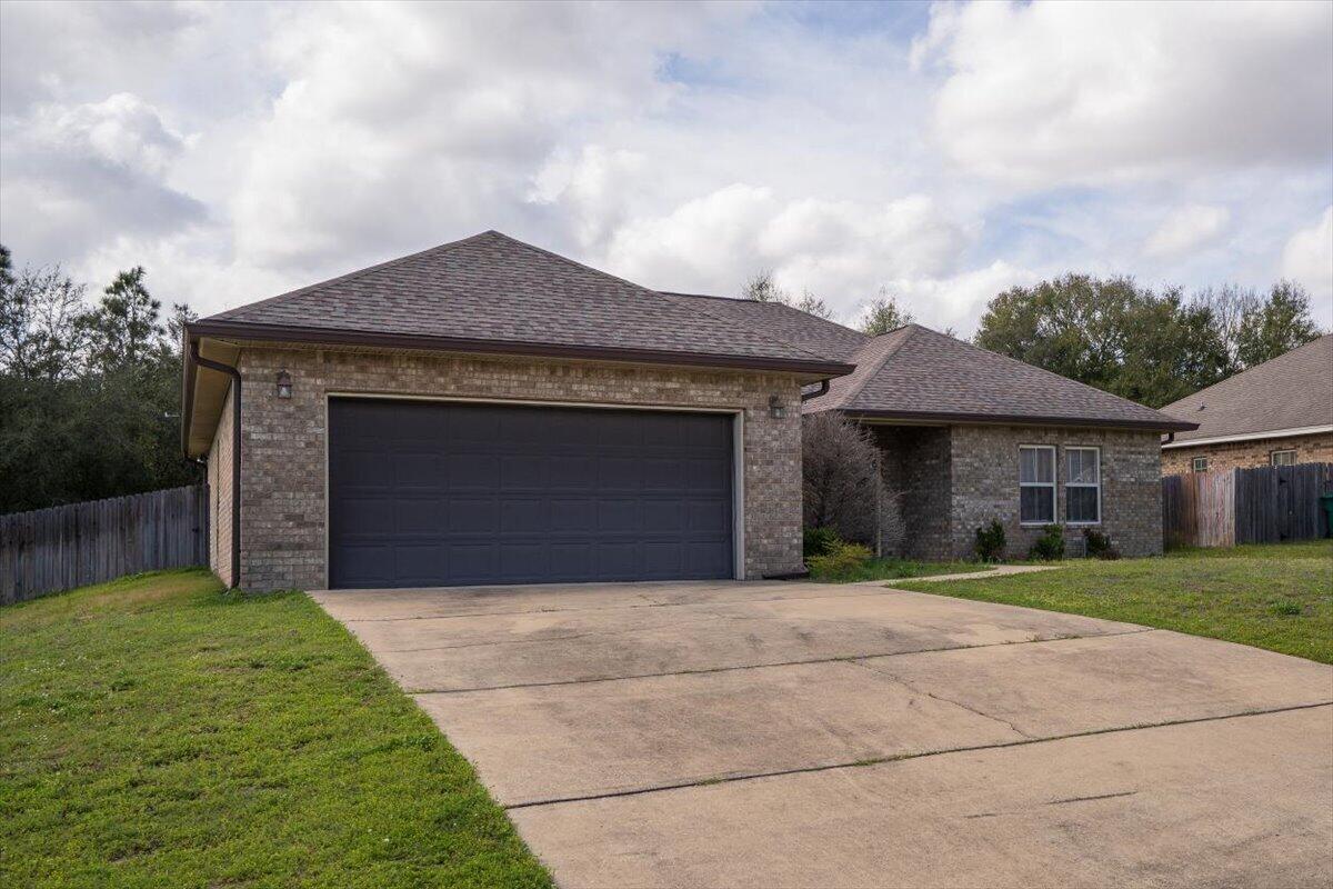 a front view of a house with a garden and yard