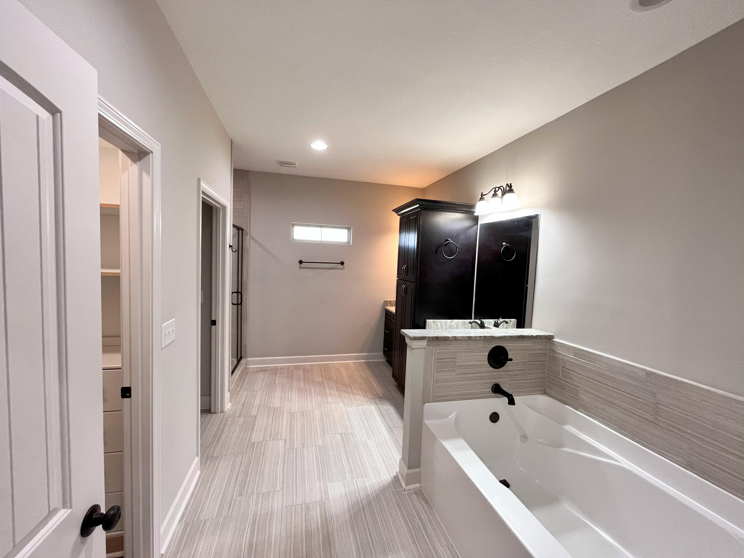 5182 Rabbit Run Crestview, FL 32539 - Photo 11 of 35 a bathroom with a bathtub and a shower