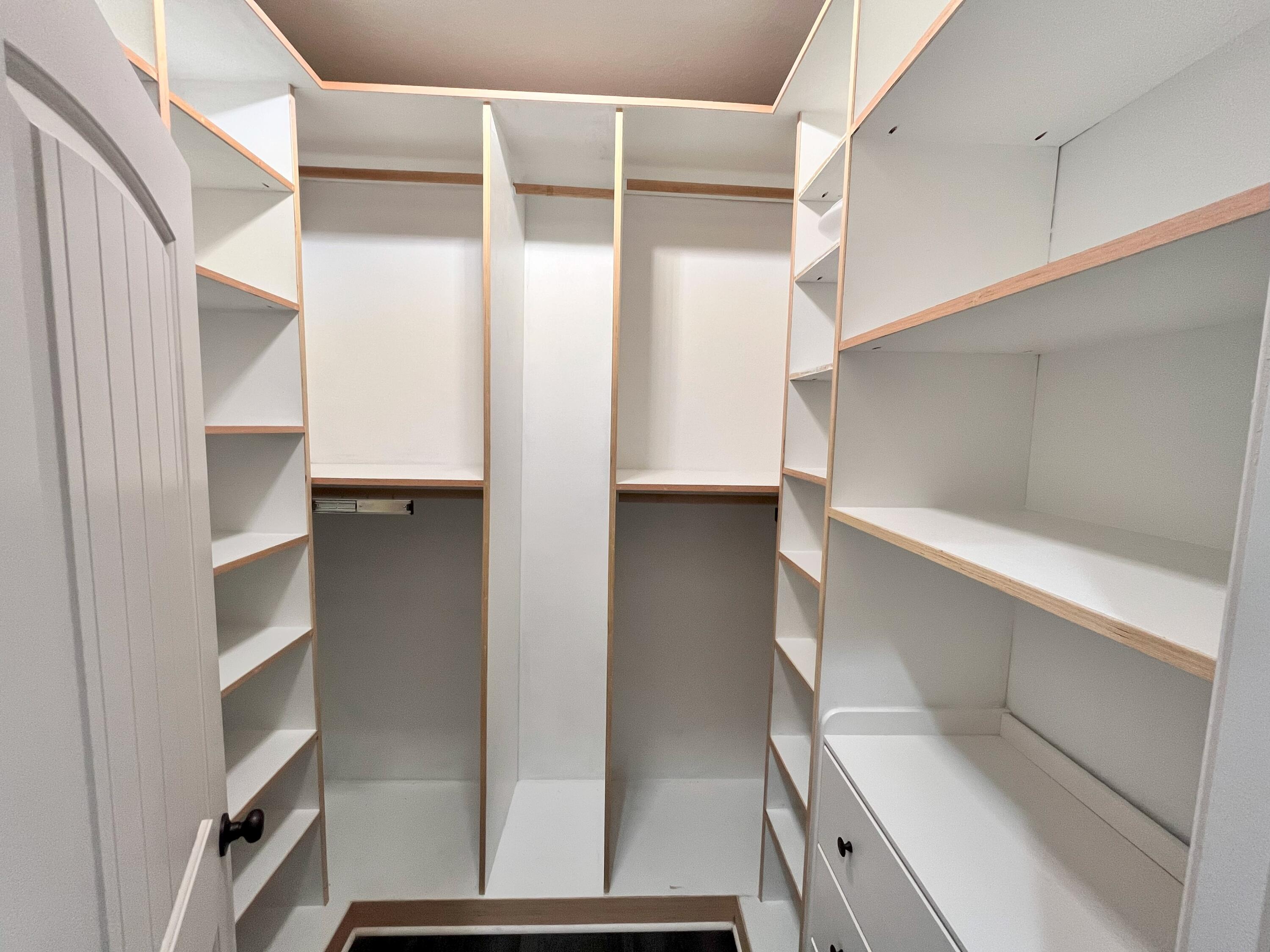 5182 Rabbit Run Crestview, FL 32539 - Photo 13 of 35 a view of walk in closet with empty racks