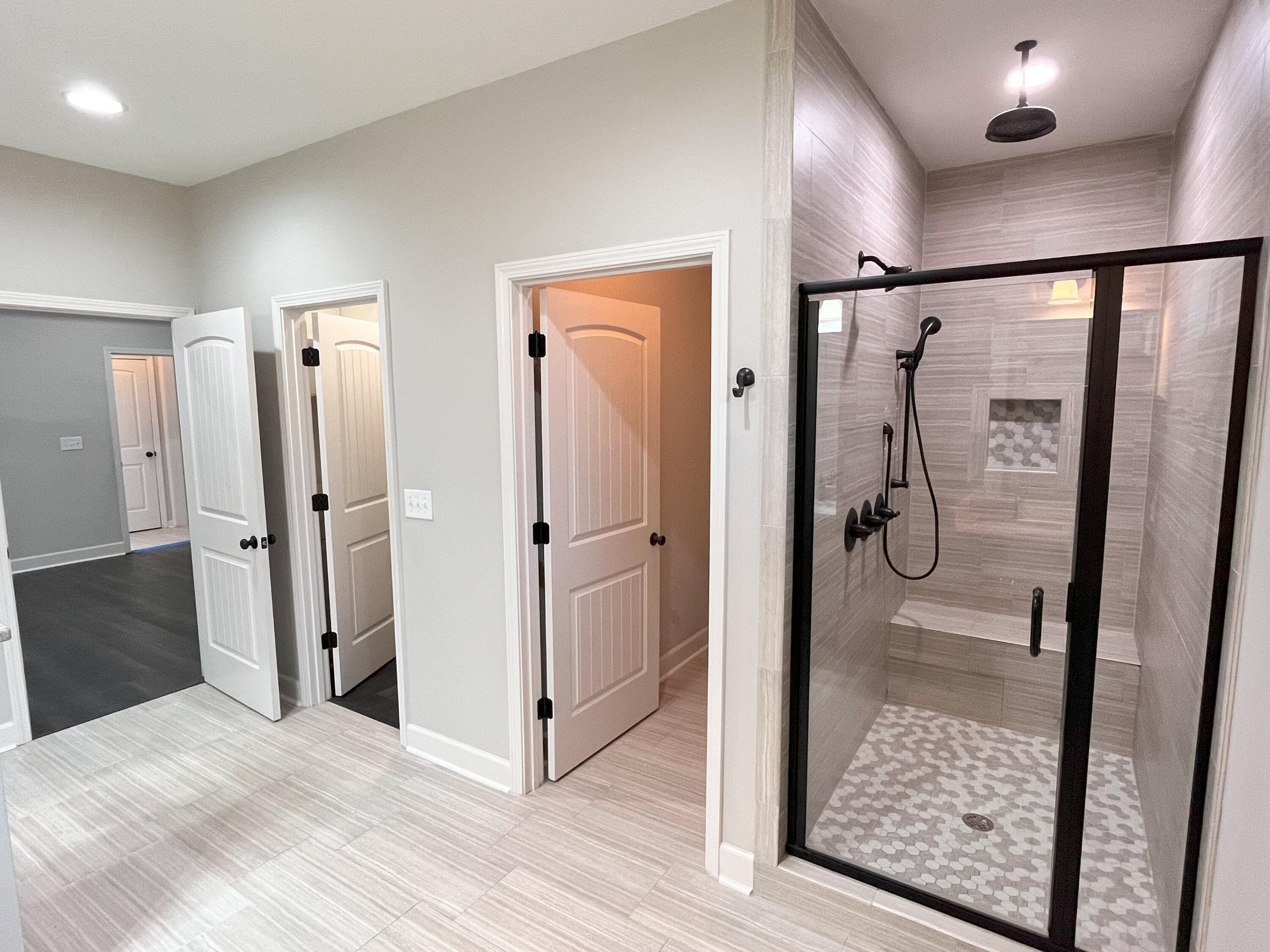 5182 Rabbit Run Crestview, FL 32539 - Photo 14 of 35 a bathroom with a glass shower door and a glass door