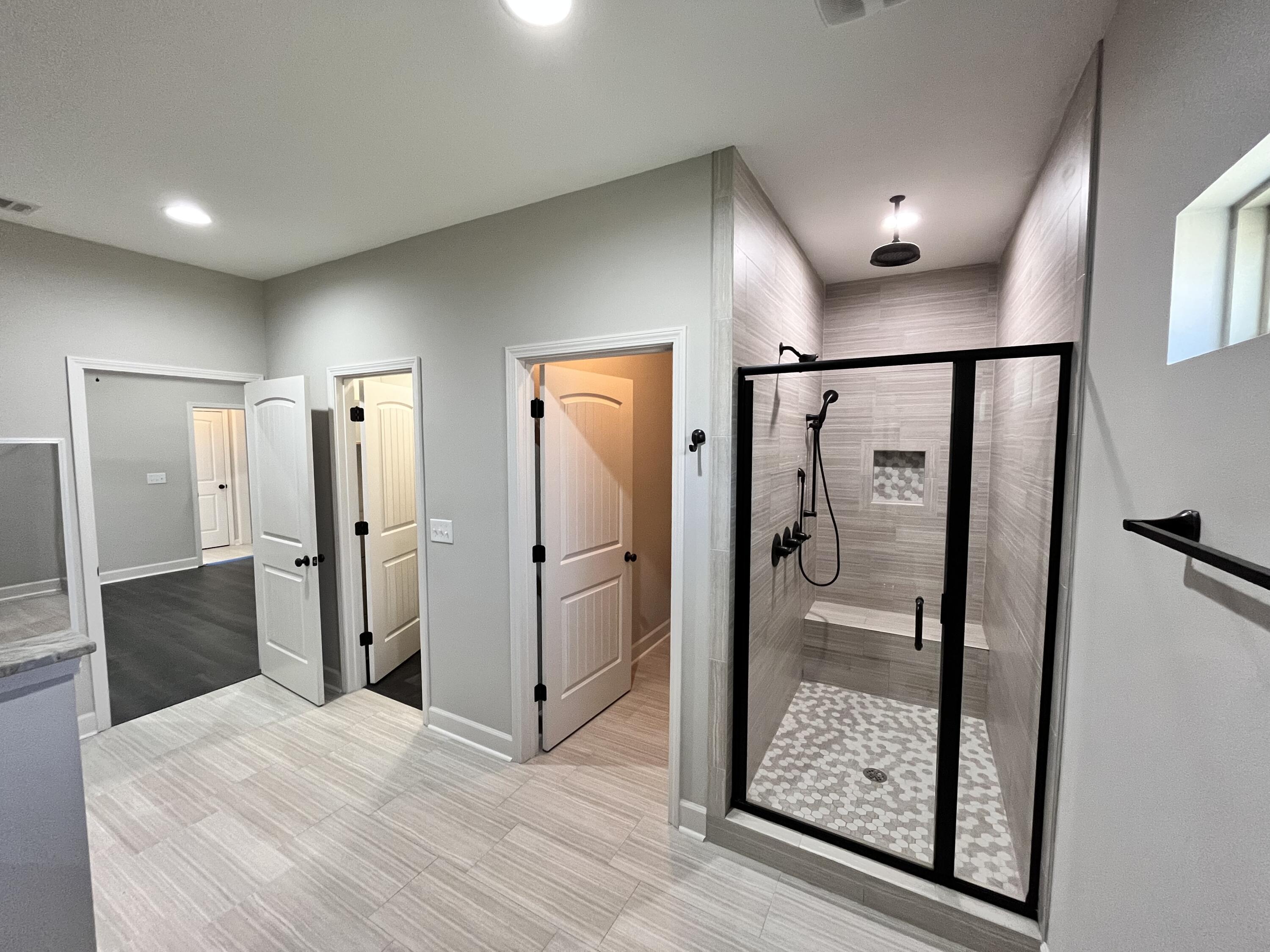 5182 Rabbit Run Crestview, FL 32539 - Photo 19 of 35 a bathroom with a glass shower door mirror and shower