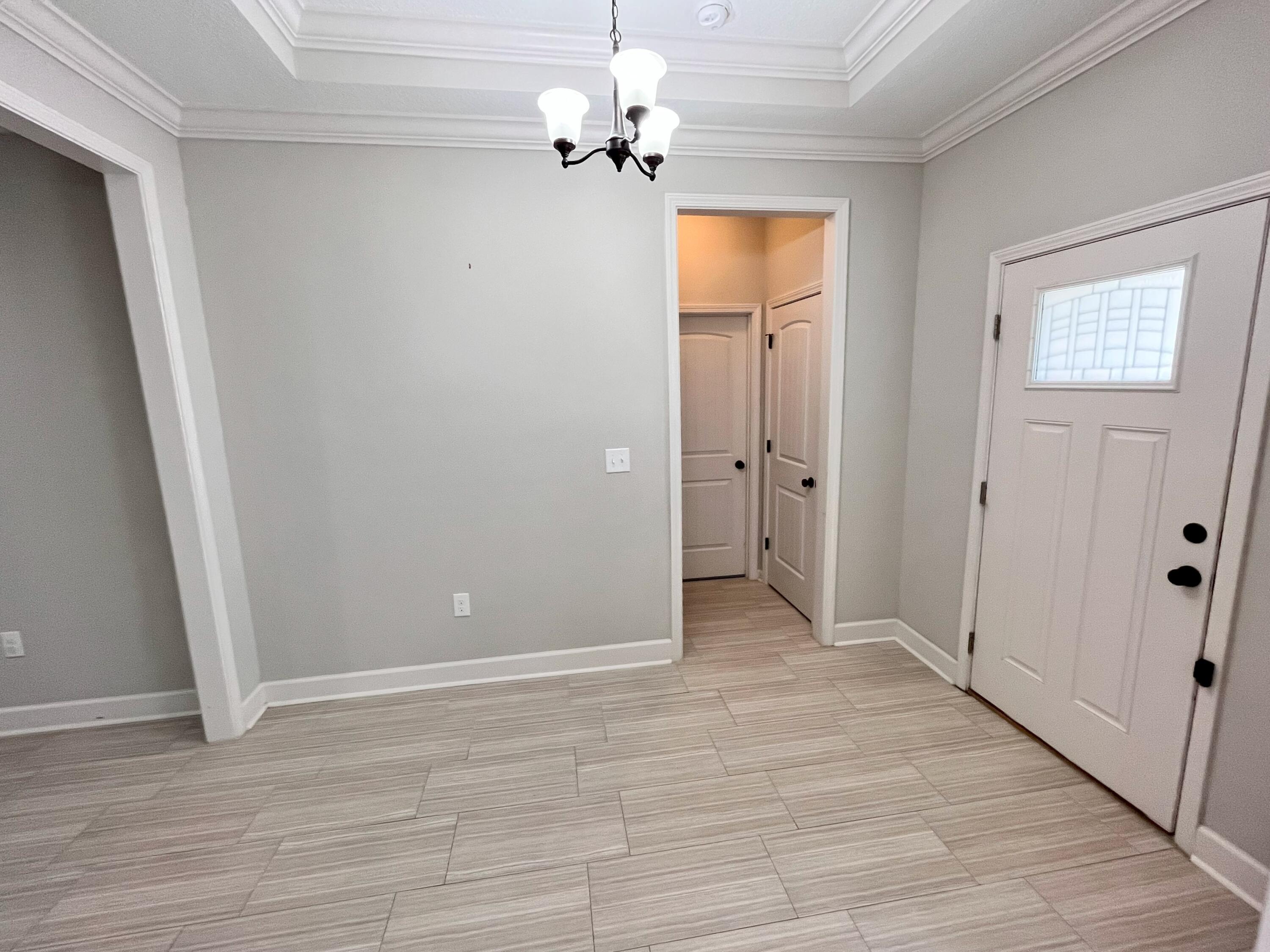 5182 Rabbit Run Crestview, FL 32539 - Photo 2 of 35 wooden floor in an empty room with a window