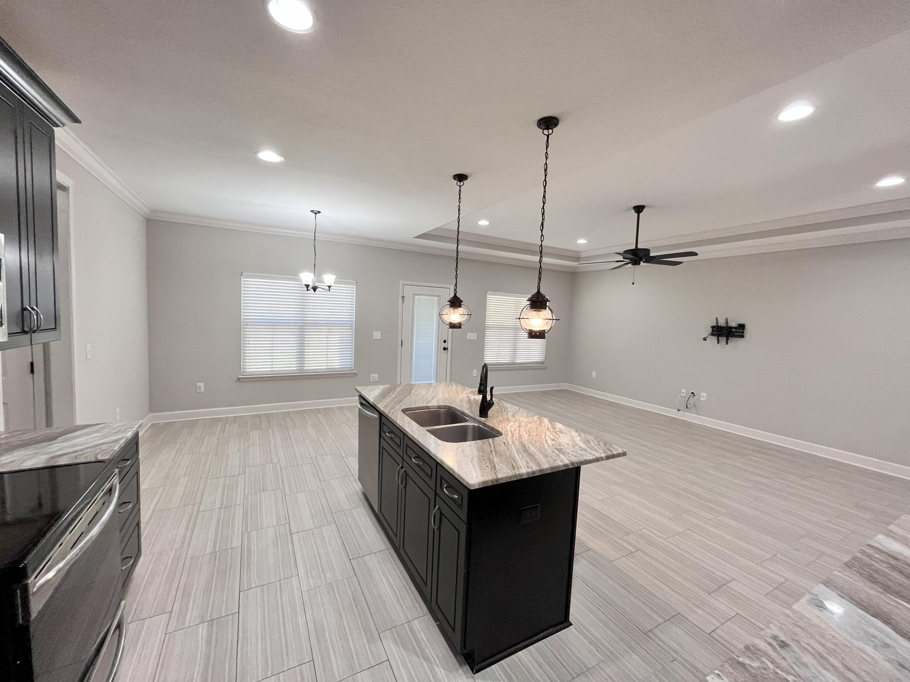 5182 Rabbit Run Crestview, FL 32539 - Photo 22 of 35 a kitchen with granite countertop cabinets a sink and appliances