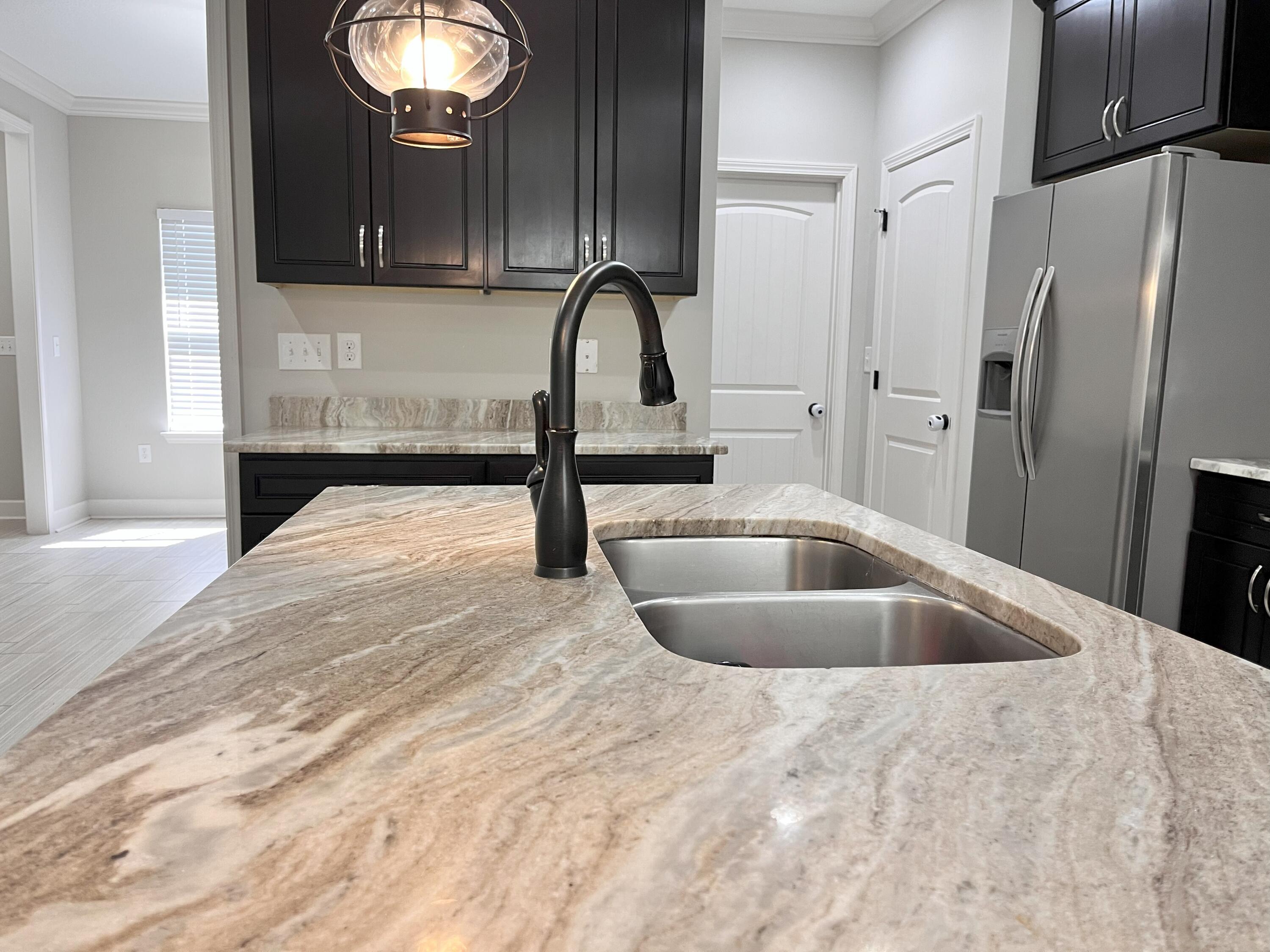5182 Rabbit Run Crestview, FL 32539 - Photo 26 of 35 a kitchen with a sink a refrigerator and cabinets