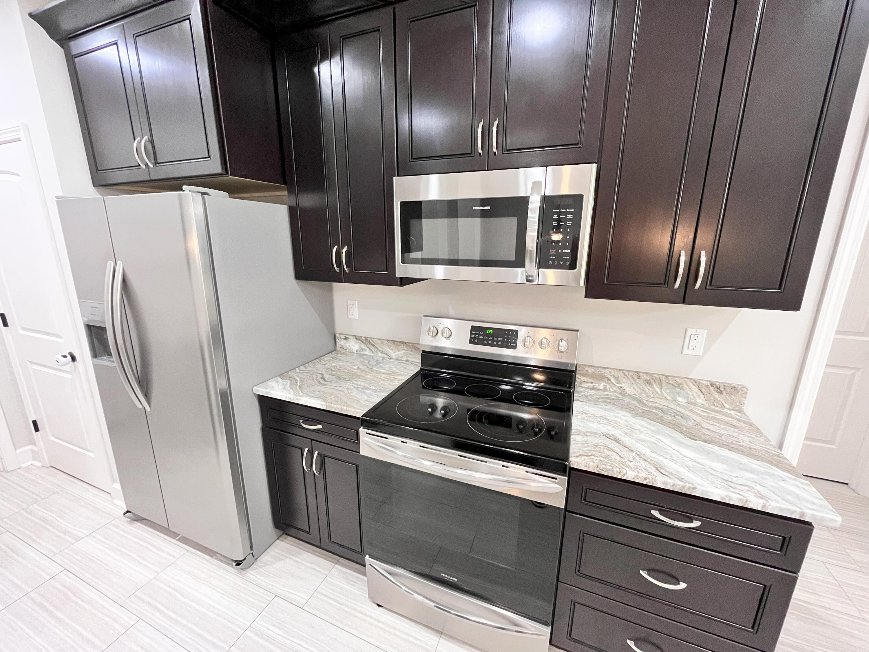 5182 Rabbit Run Crestview, FL 32539 - Photo 27 of 35 a kitchen with stainless steel appliances granite countertop a refrigerator and a sink