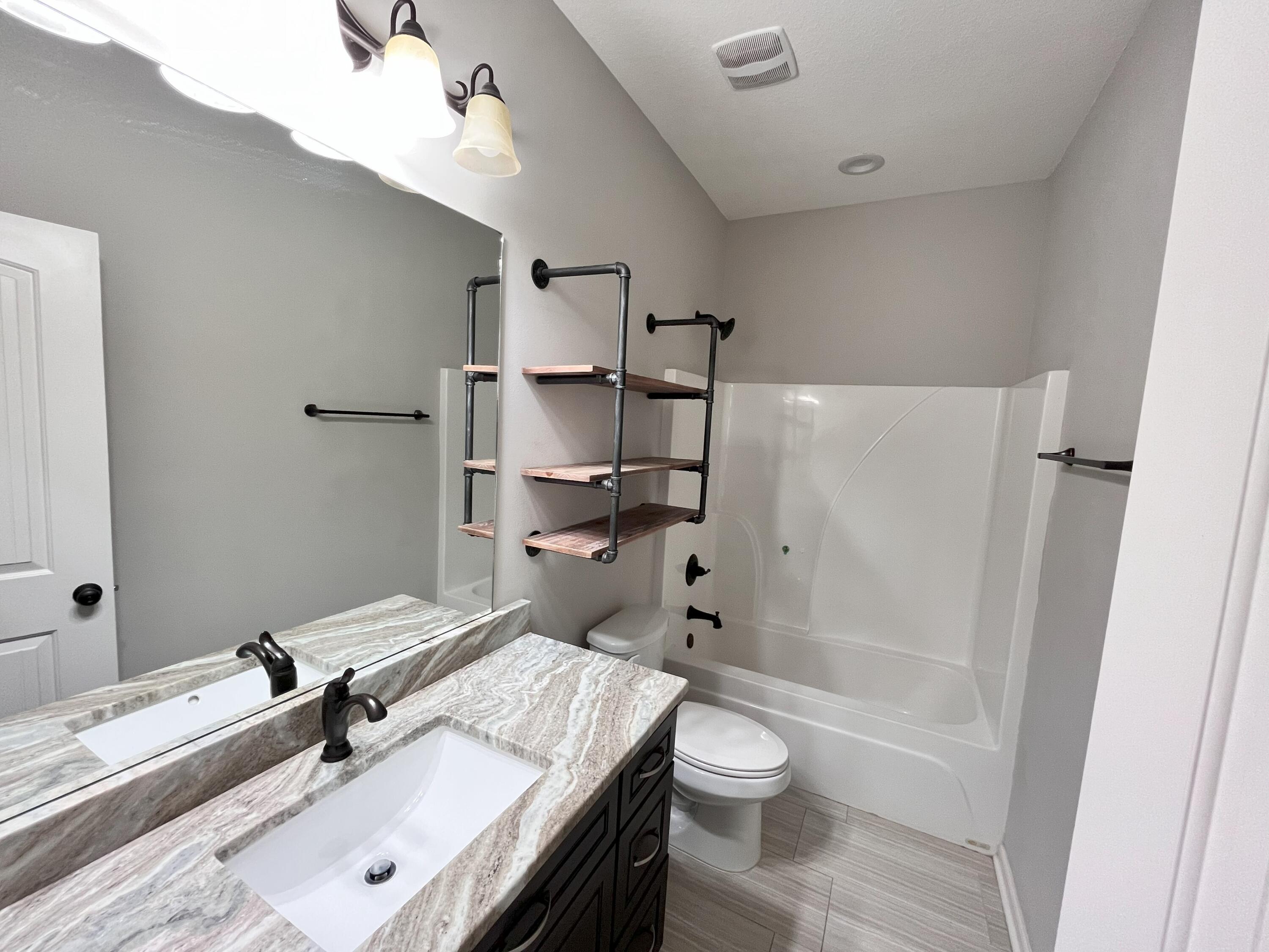 5182 Rabbit Run Crestview, FL 32539 - Photo 30 of 35 a bathroom with a sink a toilet and shower