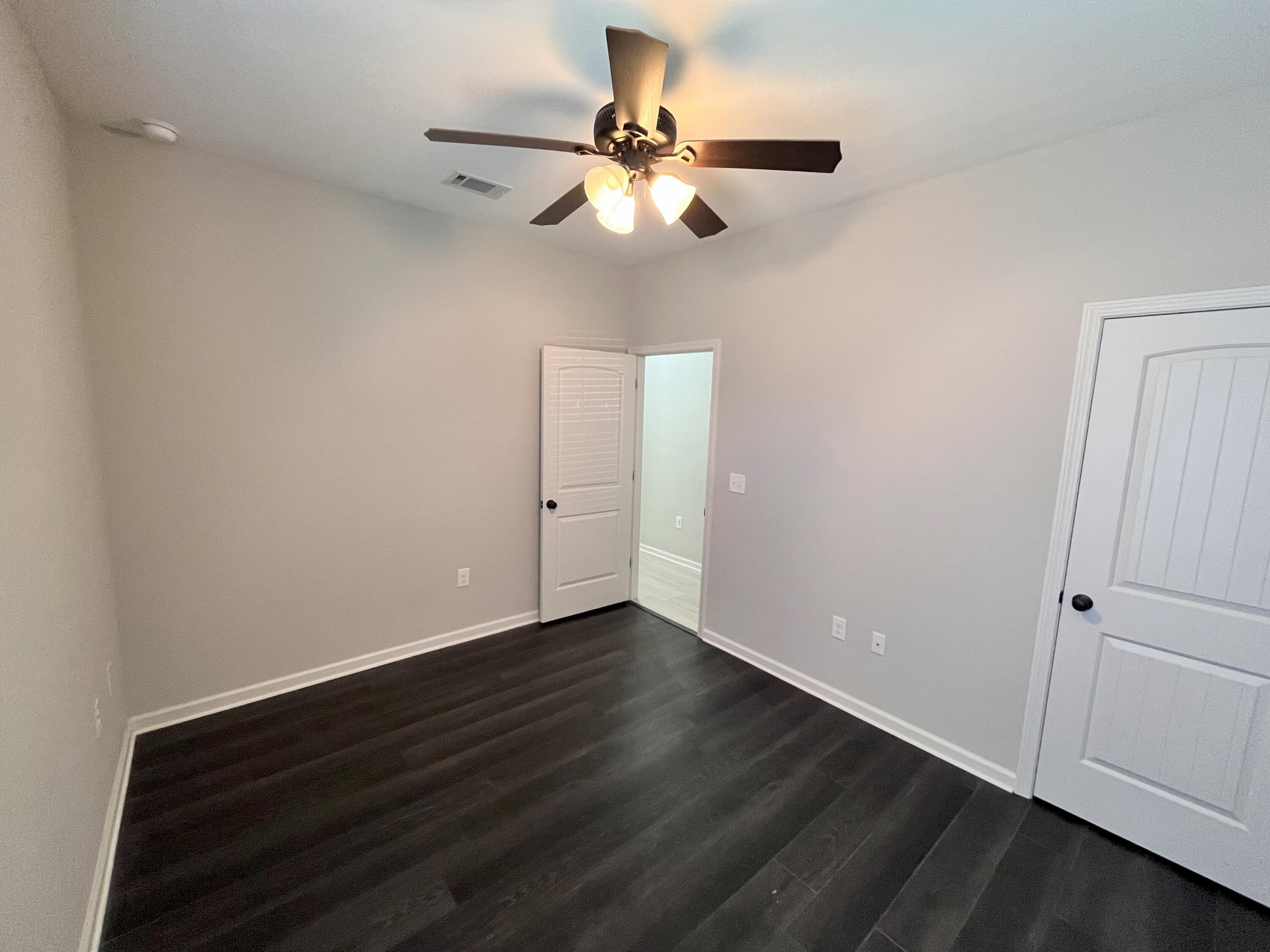 5182 Rabbit Run Crestview, FL 32539 - Photo 31 of 35 a view of an empty room with wooden floor