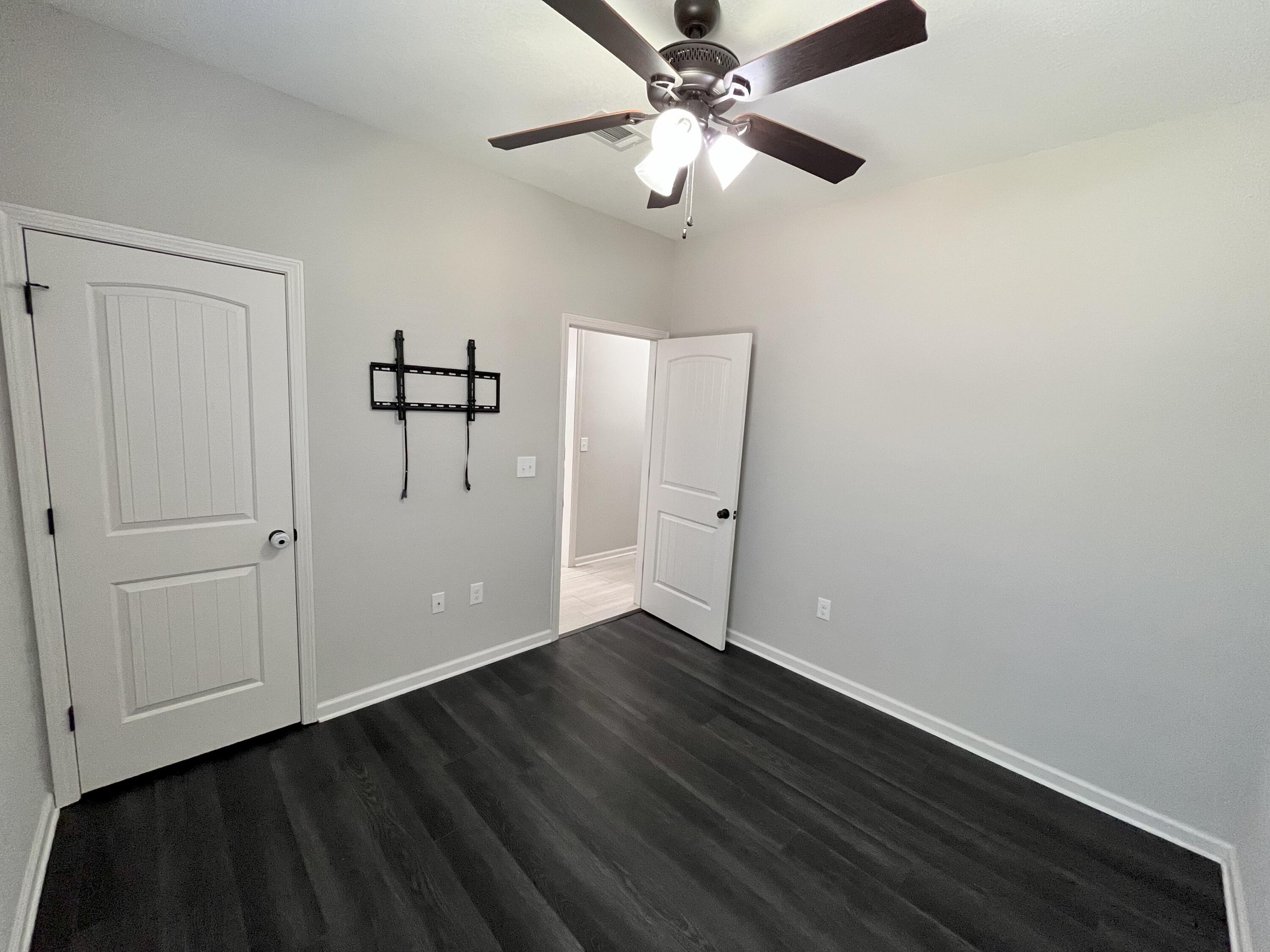 5182 Rabbit Run Crestview, FL 32539 - Photo 33 of 35 a view of an empty room with wooden floor
