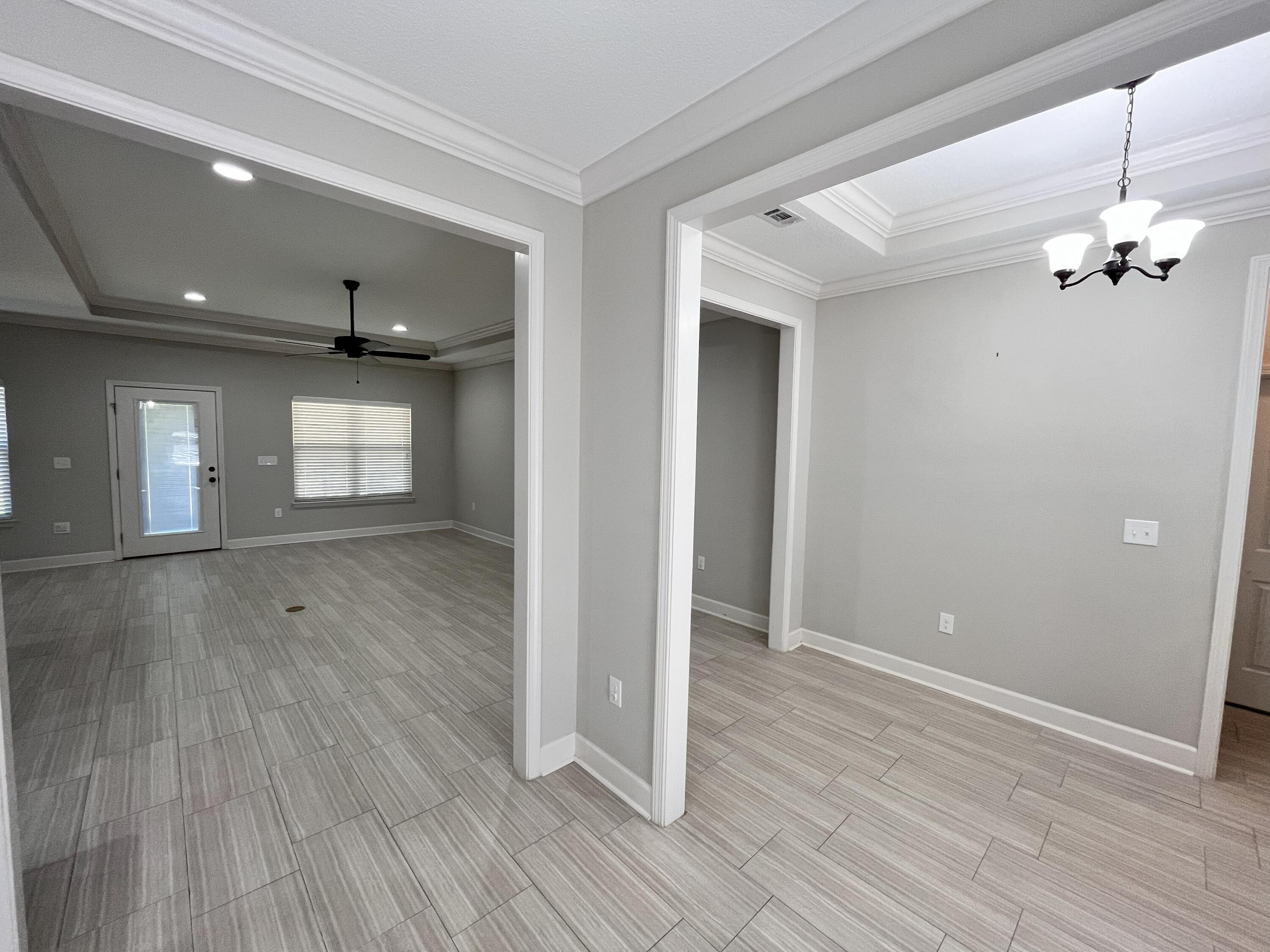 5182 Rabbit Run Crestview, FL 32539 - Photo 6 of 35 wooden floor in an empty room with a window