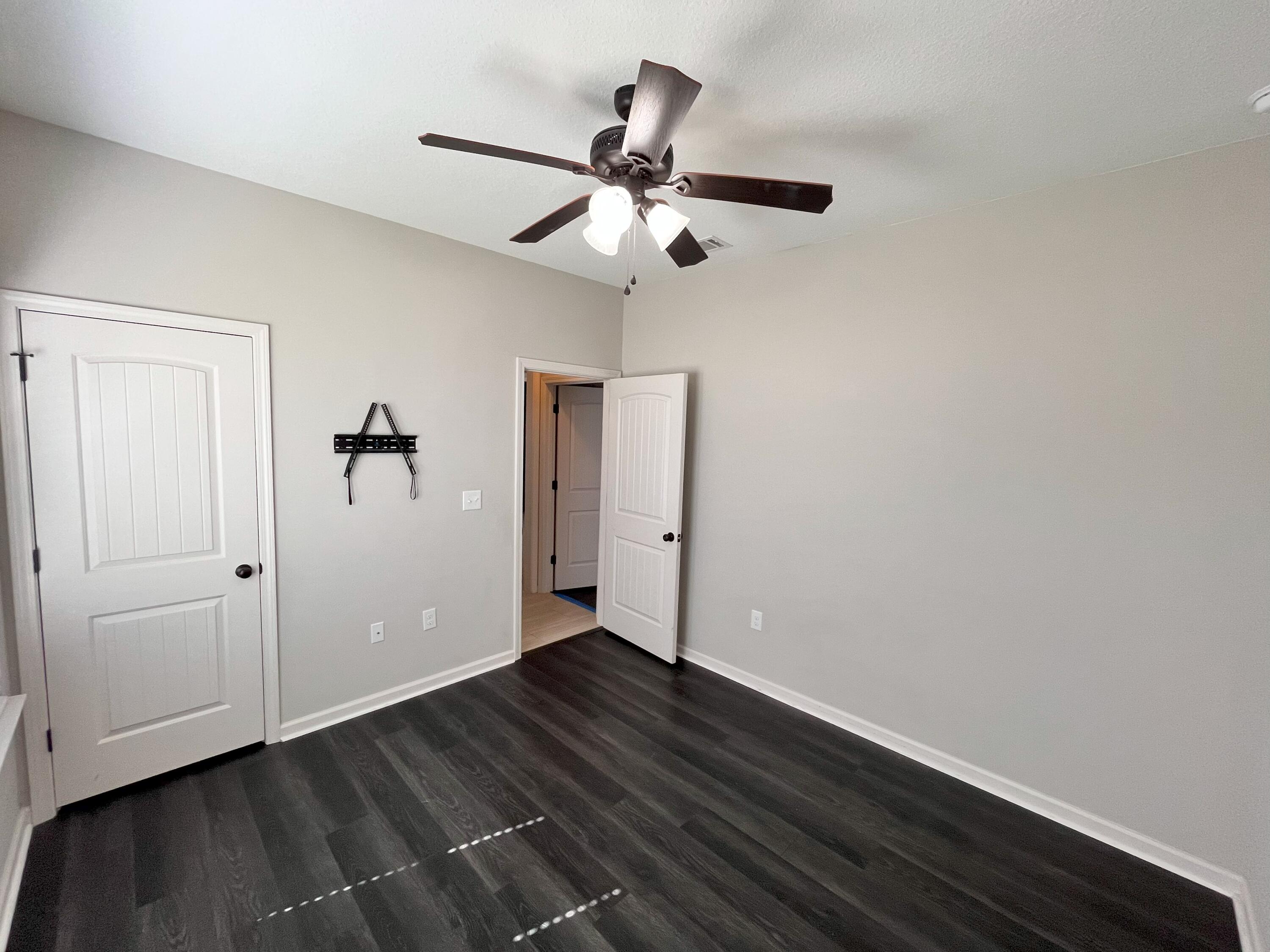 5182 Rabbit Run Crestview, FL 32539 - Photo 7 of 35 a view of an empty room with wooden floor