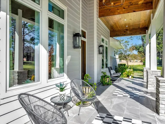 a view of a patio with couple of chairs and a fountain