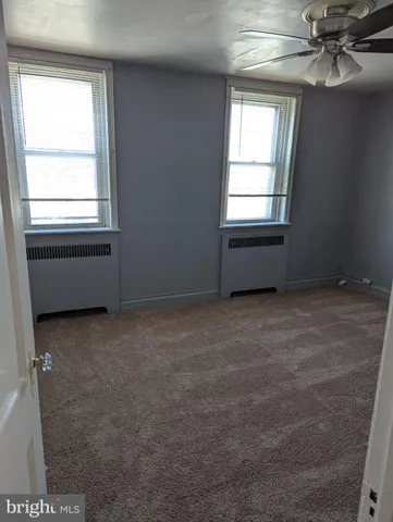 a room with a window and a ceiling fan