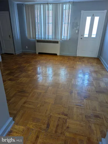 a view of a room with wooden floor and a carpet