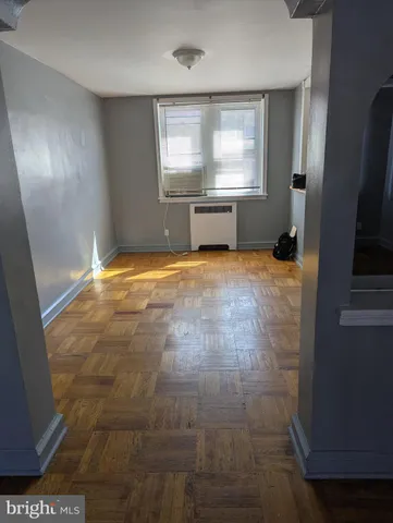 en empty room with a fireplace and windows