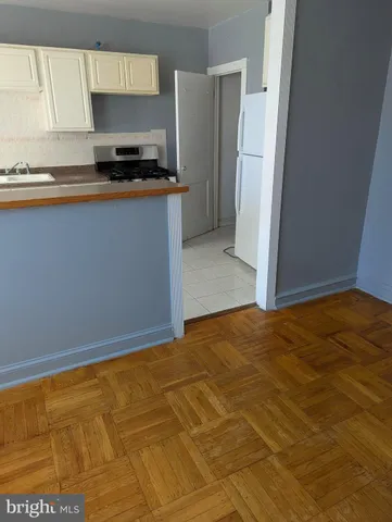 a kitchen with granite countertop a stove and a refrigerator