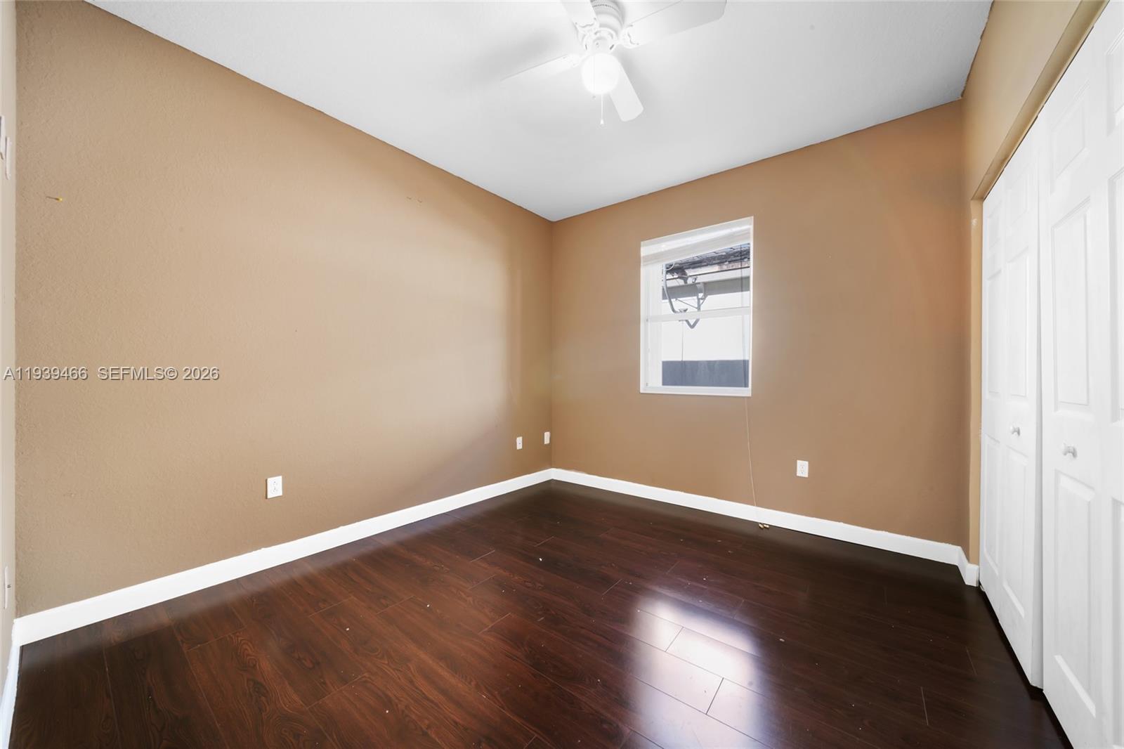 3641 Northeast 4th Street Homestead, FL 33033 - Photo 13 of 29 an empty room with wooden floor and windows
