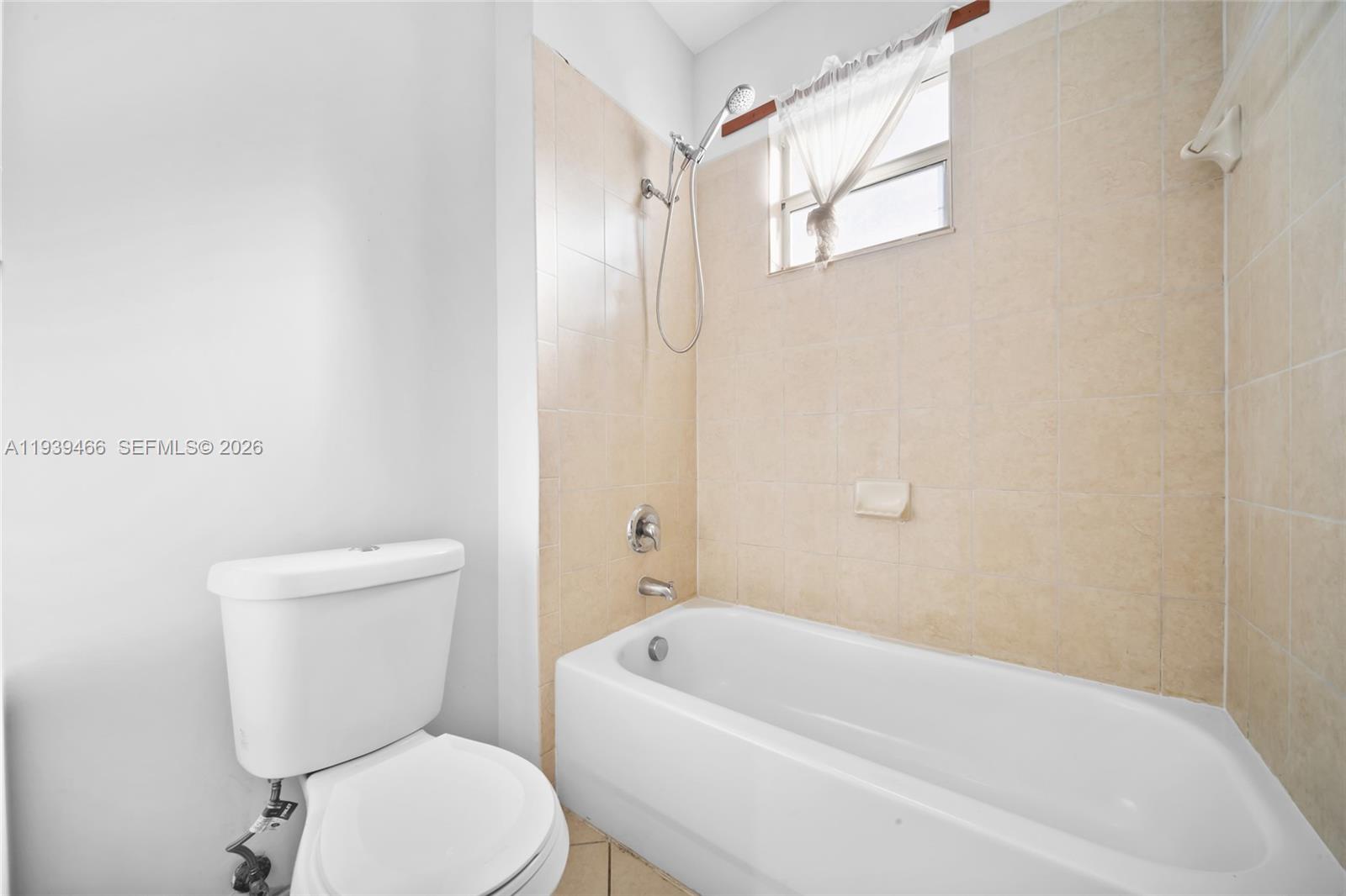 3641 Northeast 4th Street Homestead, FL 33033 - Photo 16 of 29 a white toilet sitting next to a bath tub