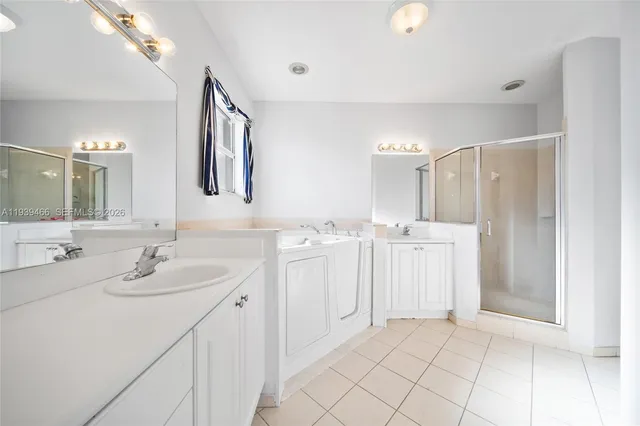 a bathroom with a double vanity sink mirror and