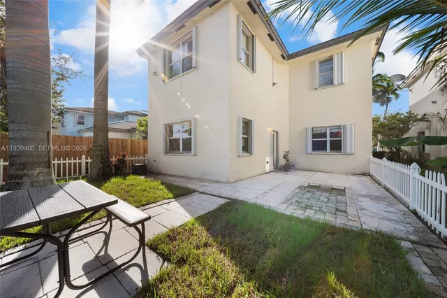a view of a patio with table and chairs and potted plants