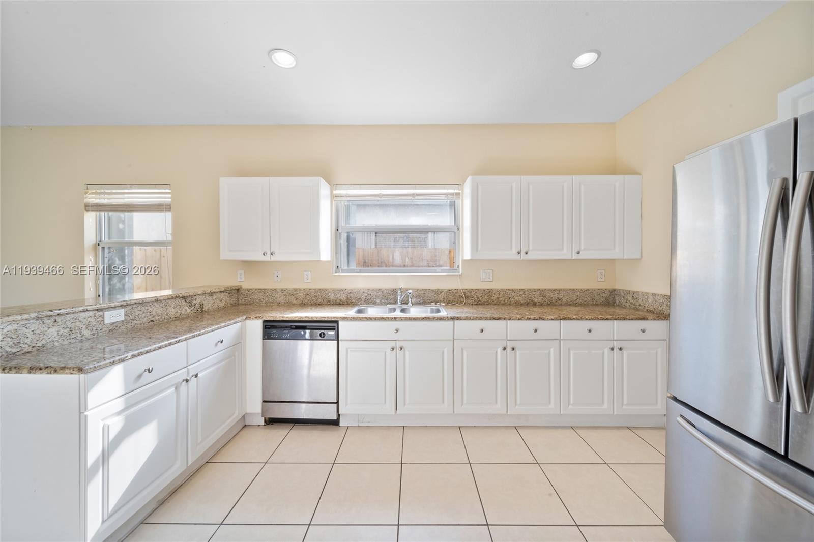 3641 Northeast 4th Street Homestead, FL 33033 - Photo 7 of 29 a kitchen with stainless steel appliances granite countertop a stove a sink and a refrigerator