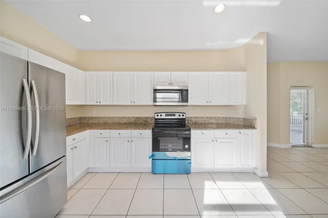 a kitchen with a stove top oven and cabinets