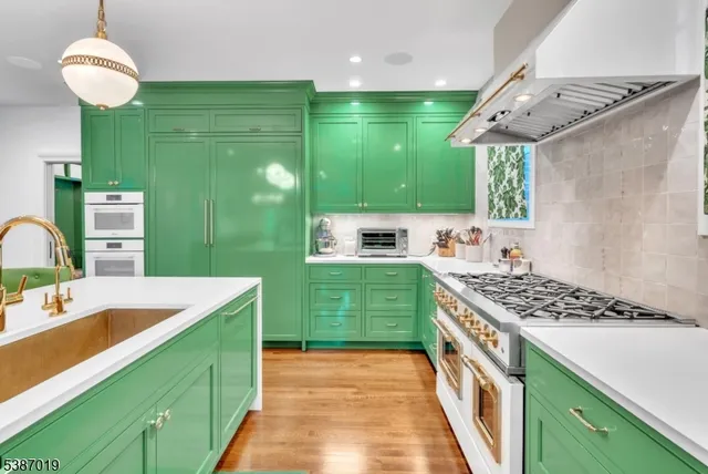 a kitchen with kitchen island granite countertop wooden cabinets and a stove
