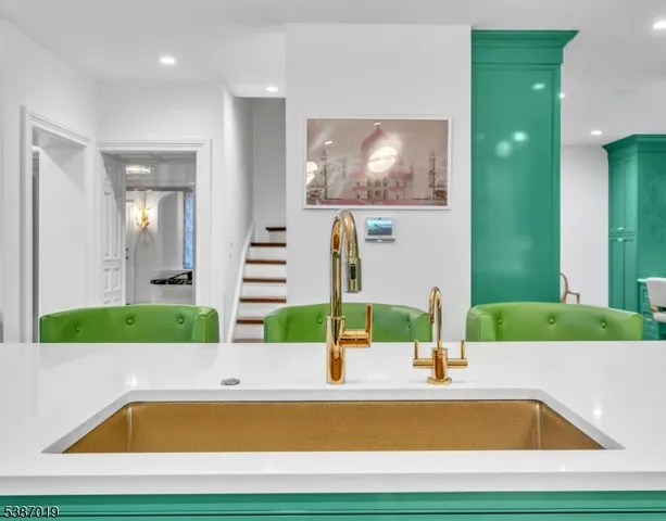 a dining room with furniture chandelier and wooden floor