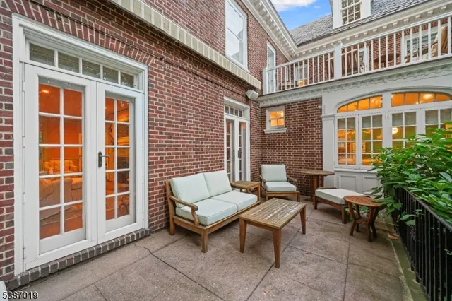 a backyard of a house with a table and chairs