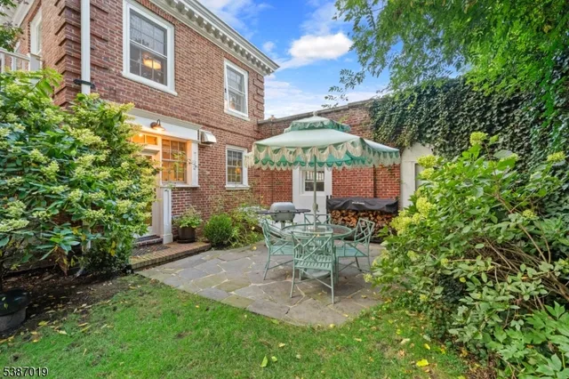 an aerial view of residential houses with outdoor space and river