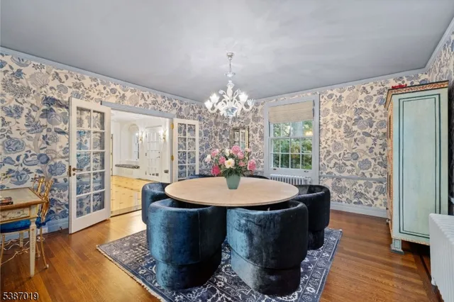 a kitchen with a table chairs and a chandelier